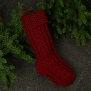 Classic red knitted Christmas stocking with cable knit pattern and hanging loop decoration
