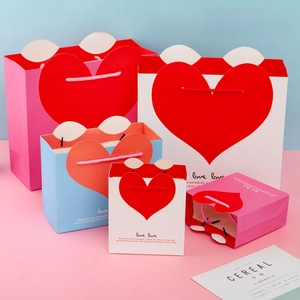 Detailed view of gift paper bags with heart-shaped handles in various sizes and colors
