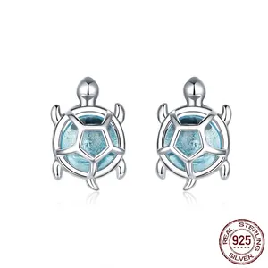 S925 sterling silver sea turtle stud earrings with light blue inlay on white background