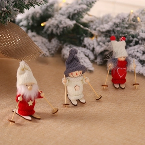 Three wooden Christmas skiing figurines with knit hats on festive rustic pine branch decor