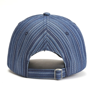 Detail view of denim baseball cap back with striped texture and metal buckle adjustment