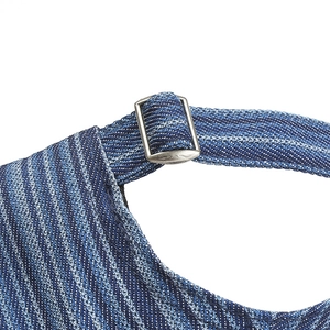 Detailed macro view of the blue denim baseball cap showing adjustable silver metal buckle