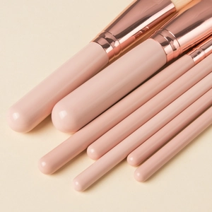 Detail view of 7 pieces mini pink makeup brush set with elegant rose gold ferrules