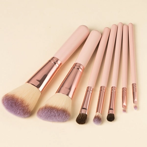 Detail view of 7 pieces pink makeup brush set with rose gold ferrules and purple bristles