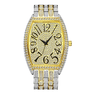 Macro shot of luxury iced-out tonneau watch case with sparkling diamonds and gold finish