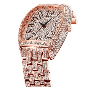Detail of rose gold luxury watch with pavé diamonds and Arabic numeral dial scale