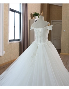 Detailed view of the off-shoulder lace wedding gown with corset lace-up back closure