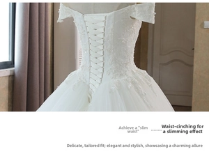 Detailed view of white lace bridal gown back with adjustable corset lace-up tie closure