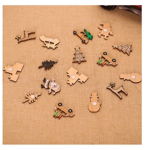 Flat lay of DIY wooden Christmas ornaments including reindeer and trees on burlap cloth