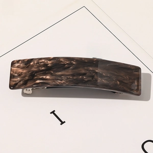 Vue détaillée de la barrette rectangulaire en acétate avec motif marbré brun et clip argent