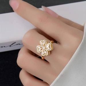 Rotating gold clover ring with diamonds for women in an elegant hand-worn jewelry style