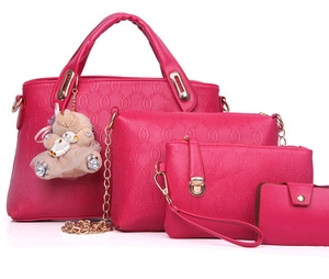 Fuchsia 4-piece handbag set featuring embossed O-patterns and cute bear charm accessory
