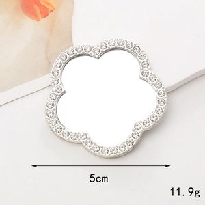 Macro detail of 5cm clover-shaped rhinestone mirror accessory for DIY phone cases