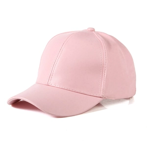 Close-up of a pink glossy baseball cap with a faux leather finish and refined stitching