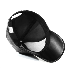 Detailed view of 100% PU leather interior and washing instructions label on black baseball cap