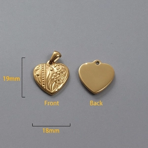 Detailed macro view of 18k gold heart pendant with floral engraving and 18mm dimensions