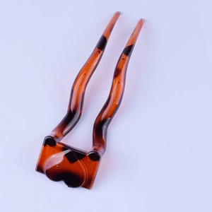 Detail of amber tortoiseshell U-shaped hair pin with a heart-shaped resin base