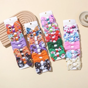 Set of 10 handmade ribbon bow hair clips for kids in various festive colors and patterns