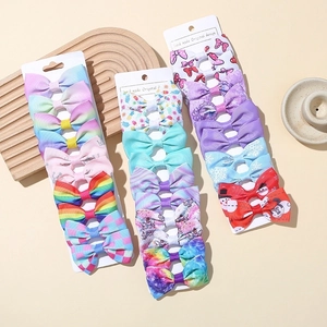 Set of 27 handmade baby ribbon bow hair clips with rainbow and floral patterns