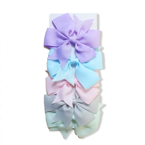 Detail of 5 solid grosgrain ribbon hair bows in various colors on a display card