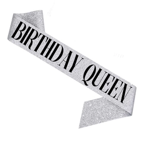 Detail of silver glitter birthday queen sash with black elegant typography for parties
