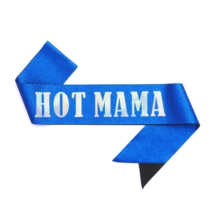 Detail of blue glitter party sash with holographic HOT MAMA lettering on white background