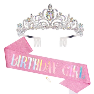 Detail of pink glitter birthday girl sash with rhinestones crown and gold safety pin