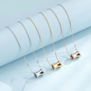 Three minimalist titanium steel necklaces in silver, gold, and rose gold finishes