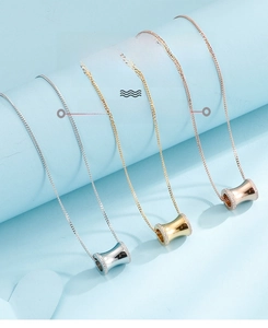 Detailed close-up of cylinder pendants with cubic zirconia in silver, gold, and rose gold