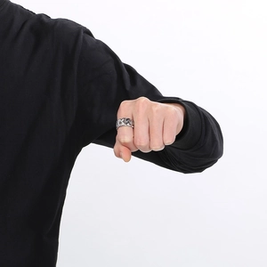 Close-up of silver Cuban link chain ring for men showing metallic texture on finger