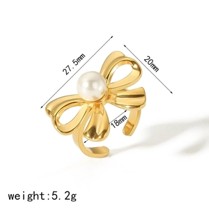 Golden bow ring with central pearl, featuring 27.5mm bow and 18mm adjustable open band