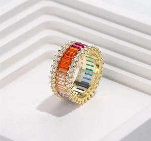 Detail of 925 silver gold-plated ring with colorful rectangular gems and round diamonds