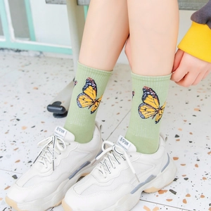 Women's light green combed cotton crew socks with large orange butterfly print