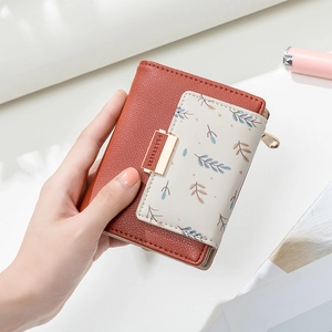 Short PU leather wallet for women with brown leaf print design and metal snap closure