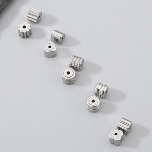 Macro shot of 304 stainless steel heart and geometric beads for DIY jewelry making
