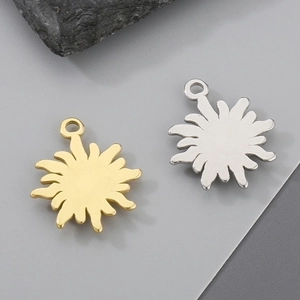 Macro shot of sun-shaped gold and silver metal charms for DIY jewelry making