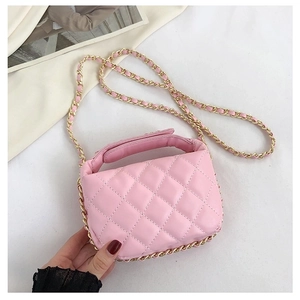 Detailed close-up of a pink quilted mini bag with gold chain strap and top handle