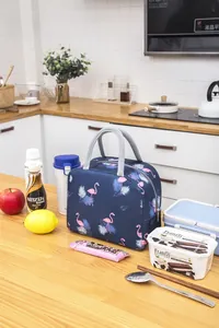 Detailed close-up of insulated lunch bag with navy blue flamingo and leaf patterns