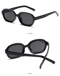 Detail view of oval concave black sunglasses with side and back folding perspectives