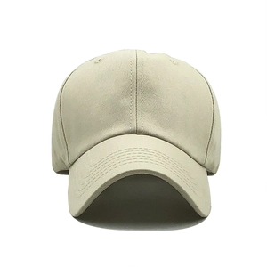 Detailed close-up of light beige cotton twill baseball cap showing stitch texture