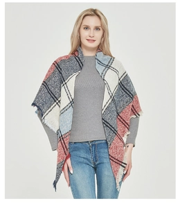 Detail of colorful plaid poncho scarf with a high collar design and fringed edges