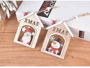 Close-up of wooden cabin Christmas ornaments with XMAS letters and reindeer patterns