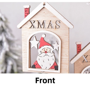 Detail of wooden Christmas house ornament featuring XMAS engraving and Santa cutout