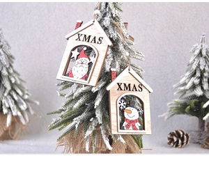 Close-up of wooden house Christmas ornament with painted Santa and snowman details