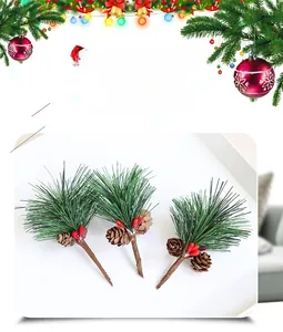Detailed view of artificial pine needles with red berries and small natural pine cones