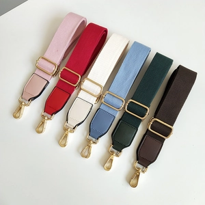 Detail view of multi-color adjustable canvas shoulder straps with golden metal buckles