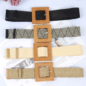 Detail view of four elastic woven belts in black, beige and brown with square buckles