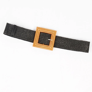 Women's black woven straw belt featuring a large square orange-brown buckle on grey background