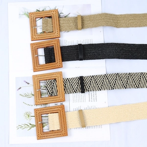 Detail of four woven belts with square wood-grain buckles in khaki, black, and beige colors