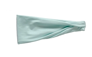 Detail of light green elastic sweatband showing soft stretch fabric texture for sports